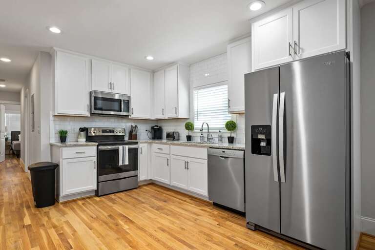 A view of the stylish and fully equipped kitchen, featuring sleek surfaces and contemporary appliances, perfect for preparing any meal with ease.