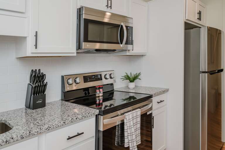 Fully equipped kitchen featuring modern appliances and ample storage.