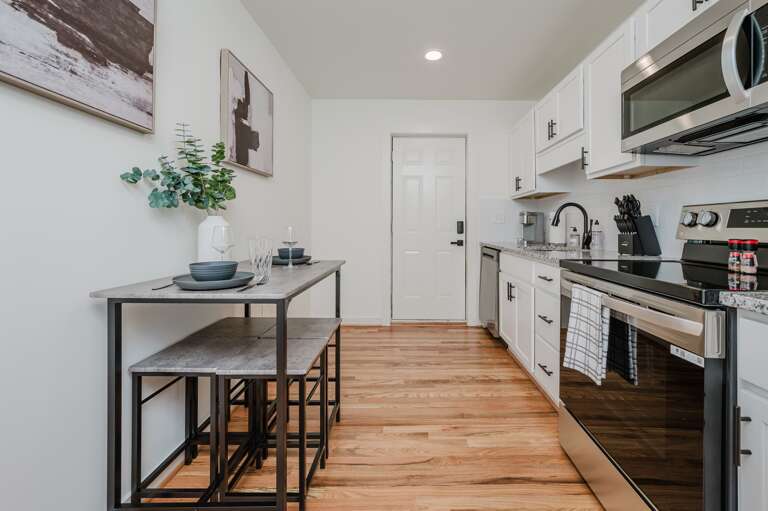 Spacious area combining cooking, dining, and relaxation in one modern setting. Spacious area combining cooking, dining, and relaxation in one modern setting.