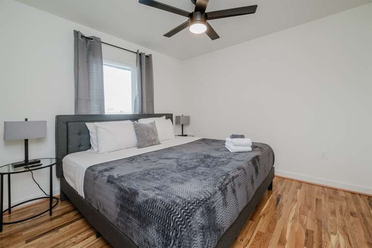 Bright and airy bedroom featuring large windows and neutral tones to enhance your rest. Bright and airy bedroom featuring large windows and neutral tones to enhance your rest.