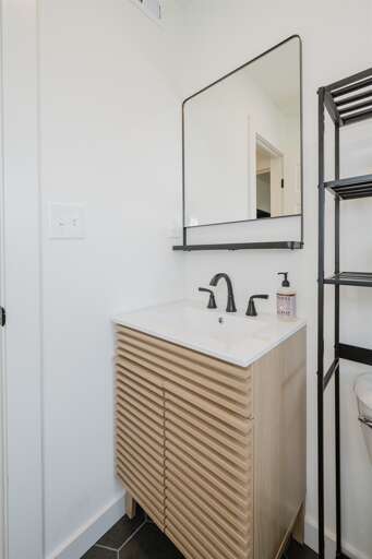 Modern bathroom vanity featuring ample storage and a large mirror, perfect for your morning and evening routines. Modern bathroom vanity featuring ample storage and a large mirror, perfect for your morning and evening routines.