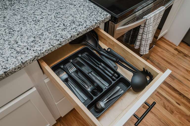 Well-organized drawers with essential cookware and utensils for your culinary needs.