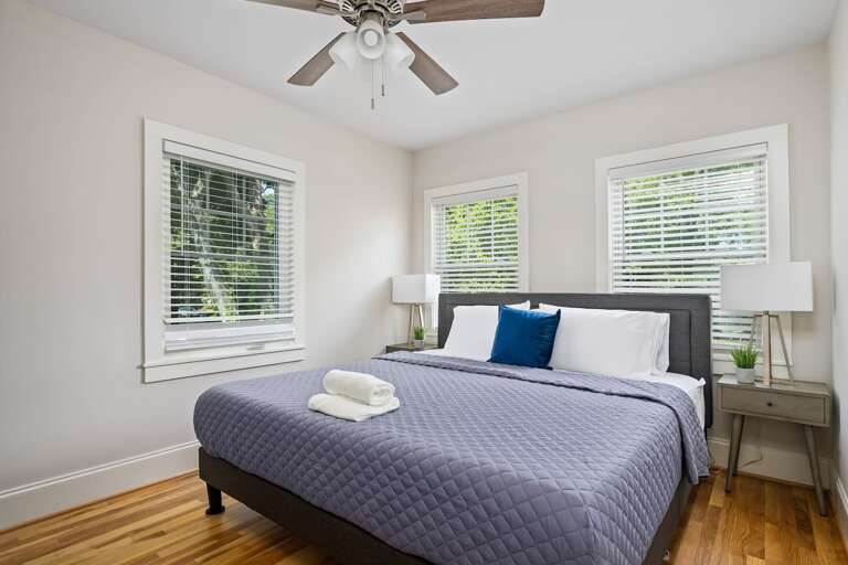 Featuring a king-size bed, tasteful furnishings, and ample natural light, this bedroom promises a restful night's sleep.