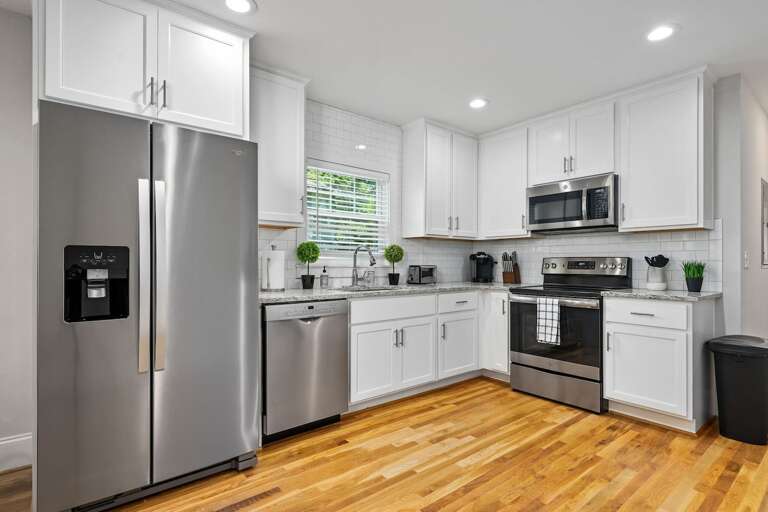 Offering a glimpse into the kitchen from the living space, highlighting the open floor plan and modern aesthetic.