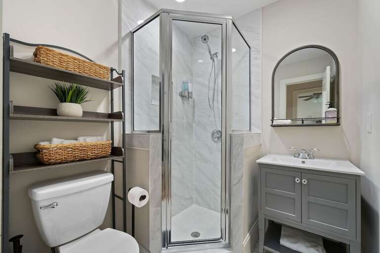 Modern bathroom amenities include a spacious shower stall, clean lines, and essential toiletries.