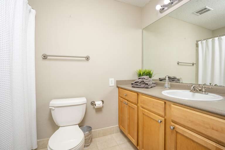 Hall Bathroom: A clean and bright bathroom featuring modern fixtures and ample space for your essentials.