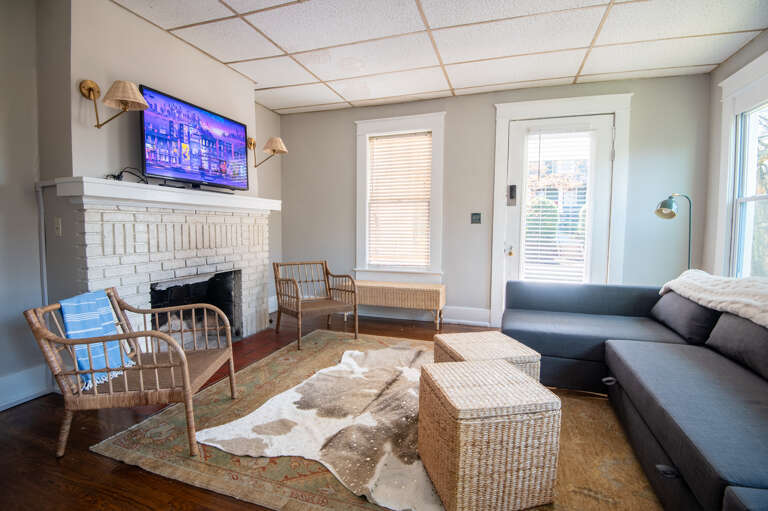Cozy living area with smart TV and vibrant art pieces.