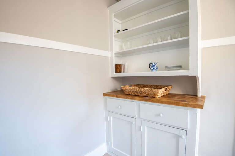 Sleek floating shelves storing kitchenware and essentials.