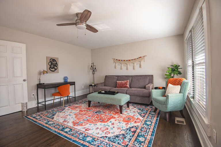 Spacious and stylish living room with vibrant decor, natural light, and ample seating. Spacious and stylish living room with vibrant decor, natural light, and ample seating.