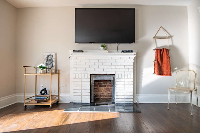 Warm and inviting decorative fireplace with a mounted TV for the perfect entertainment spot. Warm and inviting decorative fireplace with a mounted TV for the perfect entertainment spot.