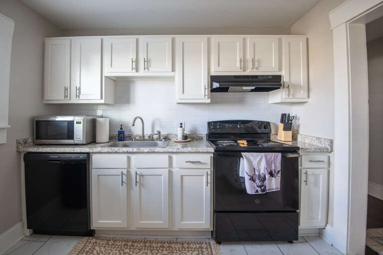 Modern kitchen with stainless steel appliances and all the essentials for cooking Modern kitchen with stainless steel appliances and all the essentials for cooking