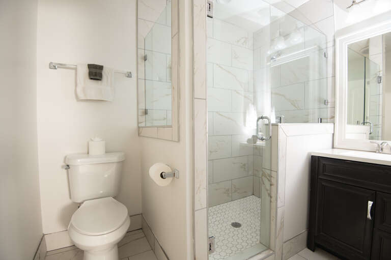 Sparkling clean bathroom with walk-in shower, fresh towels, and everything you need to refresh.
