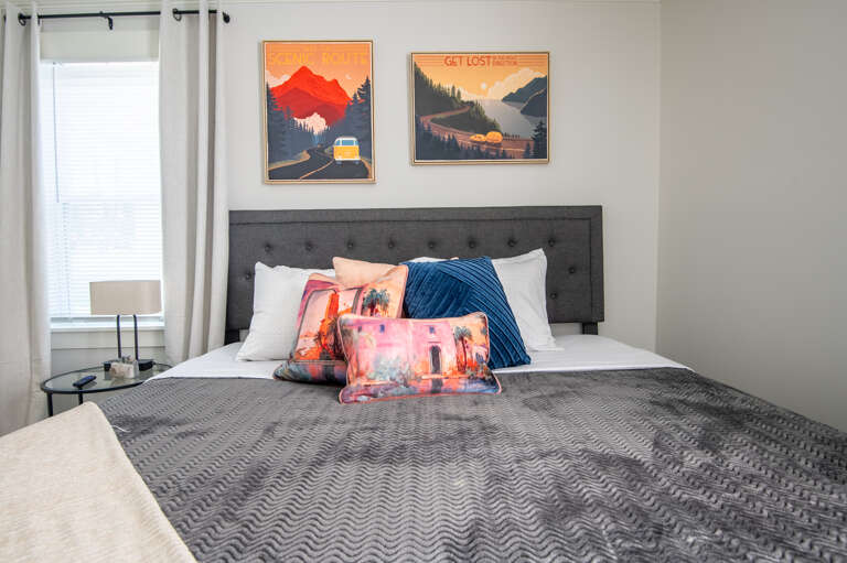 Relax in this cozy king bedroom with bold mountain art and plush bedding for a peaceful night’s rest.
