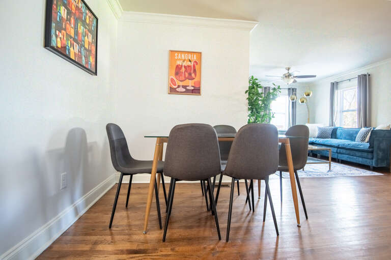 Dining table with colorful artwork—great for group meals or game night with friends and family.