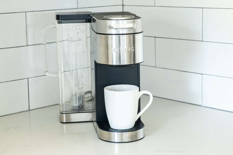 Wake up right with this convenient coffee maker—mugs and coffee essentials provided.
