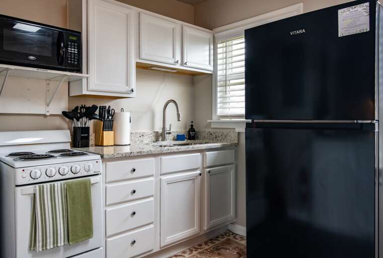 Modern kitchen, fully equipped for any culinary adventure, featuring sleek appliances and ample counter space. *NO DISHWASHER*