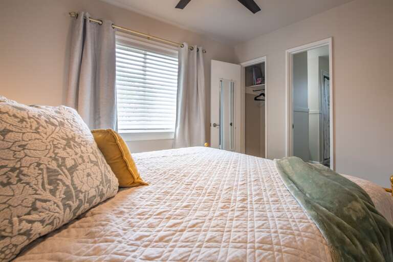 Spacious and airy bedroom providing a tranquil retreat with plush bedding and neutral tones.