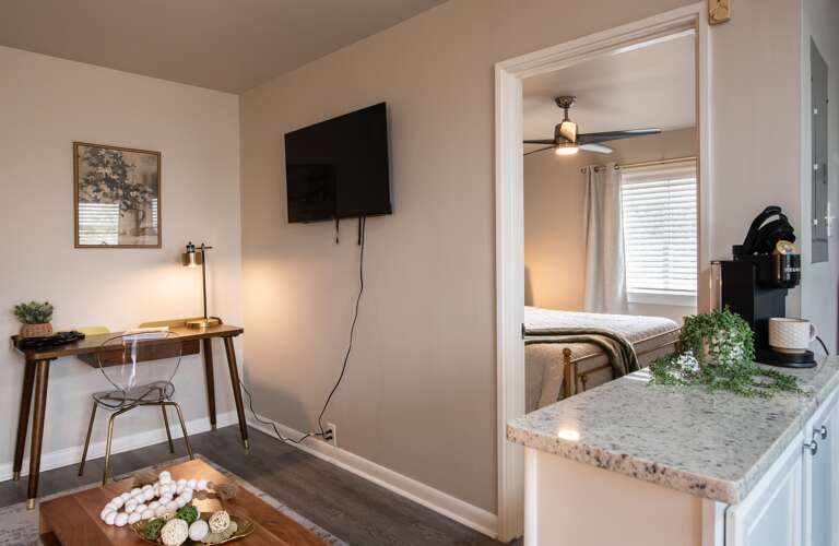 Efficient workspace paired with a flat-screen TV, blending productivity with leisure.