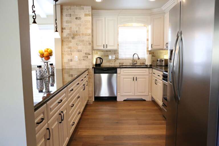 Spacious Kitchen With Stainless Steel Appliances And Light Cabinetry
