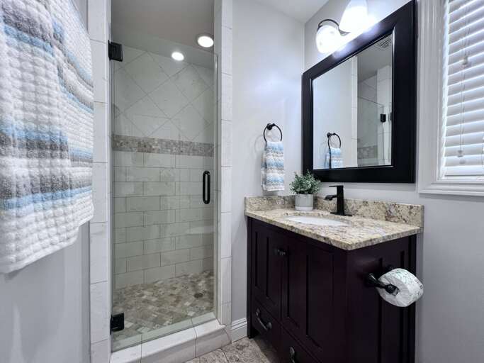 Master Bathroom #1 Travertine floor, custom raised panel cabinetry. Travertine/marble counter top. Upgraded shower with travertine/marble set in custom pattern with accents.