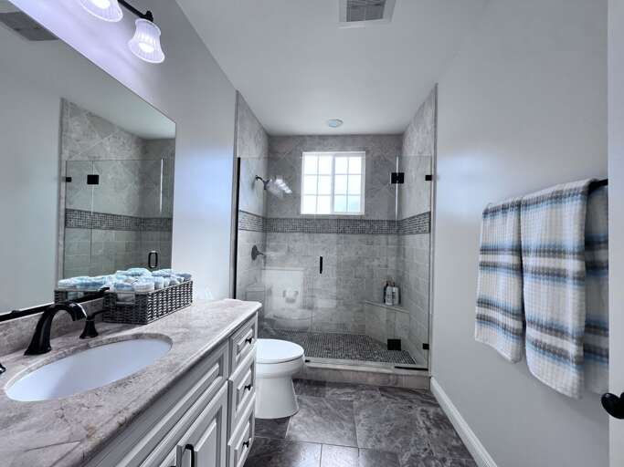 Master Bathroom #2 Travertine/marble floor and custom raised panel cabinetry. Granite counter tops and upgraded custom designed shower with travertine/marble with custom inlays.