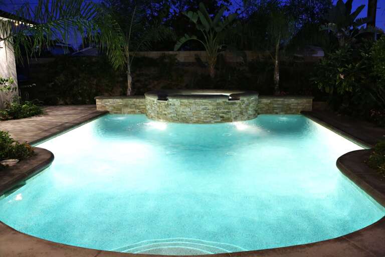 Nighttime View Of Luminous Pool In A Lush Garden Setting At A Vacation Rental Nighttime View Of Luminous Pool In A Lush Garden Setting At A Vacation Rental