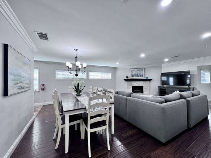 Spacious Living Space With Sectional Sofa, Dining Set, And Fireplace
