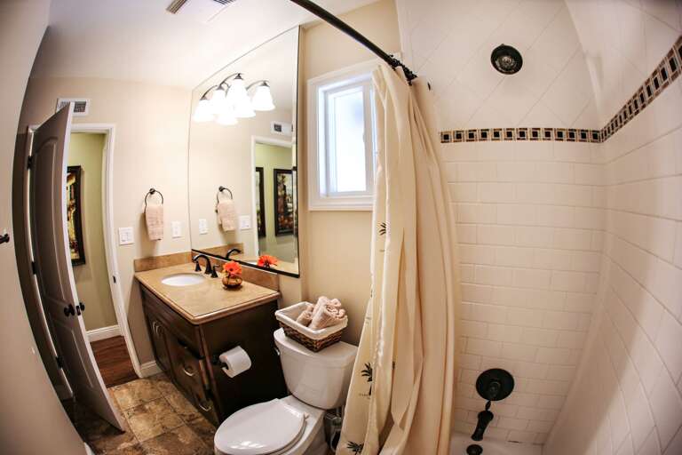 Bright Bathroom With Beige Tiles, Wooden Cabinet, And Mirror Bright Bathroom With Beige Tiles, Wooden Cabinet, And Mirror