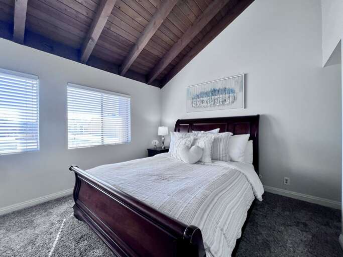 Bright Bedroom Beams, Plush Pillows On Polished Bed In Vacation Rental Bright Bedroom Beams, Plush Pillows On Polished Bed In Vacation Rental