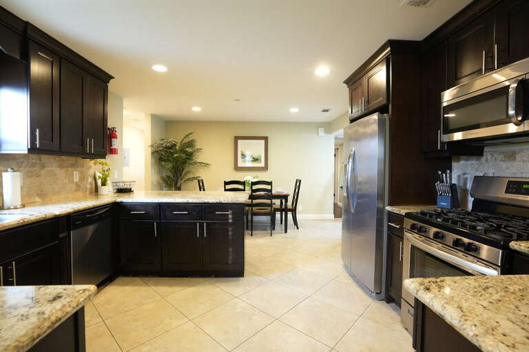 Spacious Kitchen With Stainless Steel Appliances And Granite Countertops