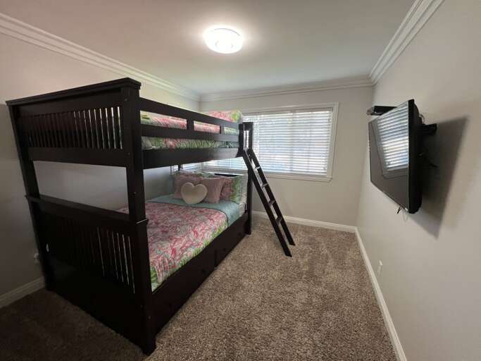 Full over full bunk bedroom with girl bedding