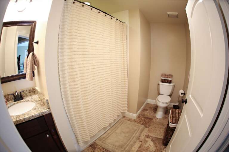 The bathroom features a shower/tub combo