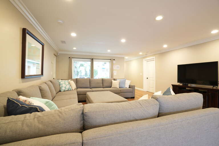 Spacious Living Space With Large Sofa And Flatscreen TV Spacious Living Space With Large Sofa And Flatscreen TV