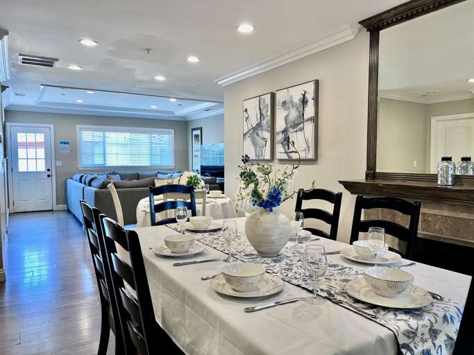 Dining Space Set With Dishes, Adjacent Sleek Sitting Area, Shining Surfaces