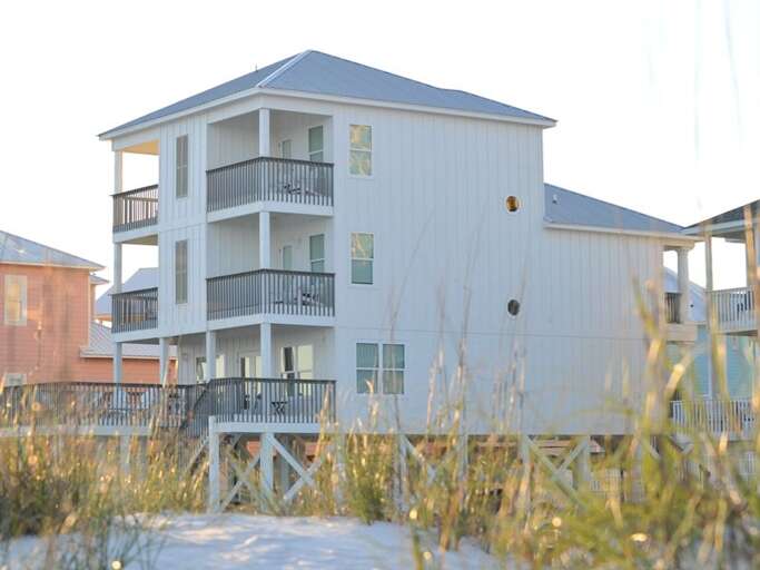 South-side of home. There are 4 private balconies off the master bedrooms which over amazing unobstructed gulf views.