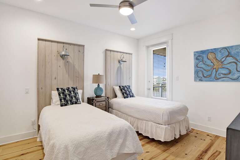 2 nd floor bedroom on north west side of house, has two twin xl beds ensuite bath and balcony to north side of house.