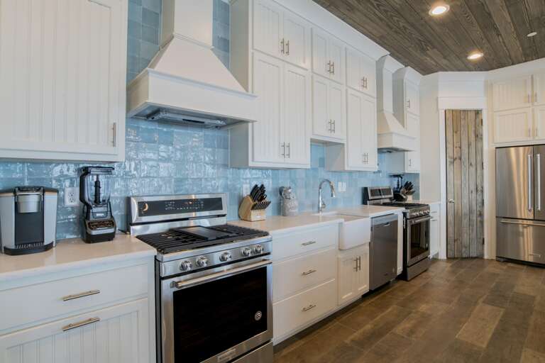 Kitchen with 3 dishwashers, 3 full size refrigerators, 2 gas range cook tops and and 4 ovens.