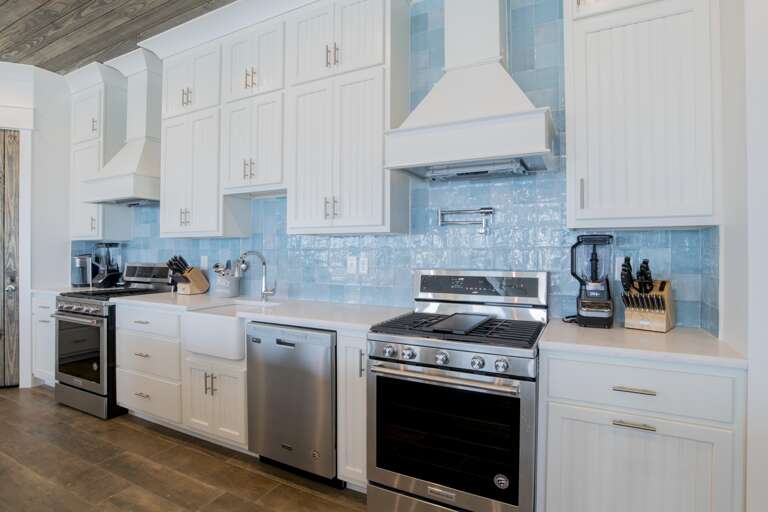 Kitchen with 3 dishwashers, 3 full size refrigerators, 2 gas range cook tops and and 4 ovens.