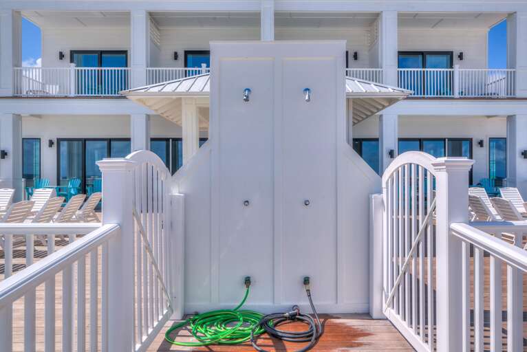 2 Shower heads on south side of privacy wall.
