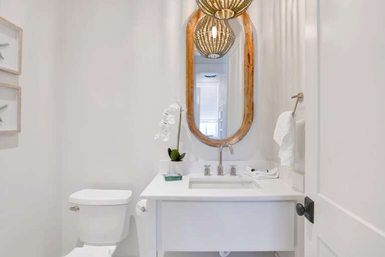 Half bath across from bunk room, on main level off den.