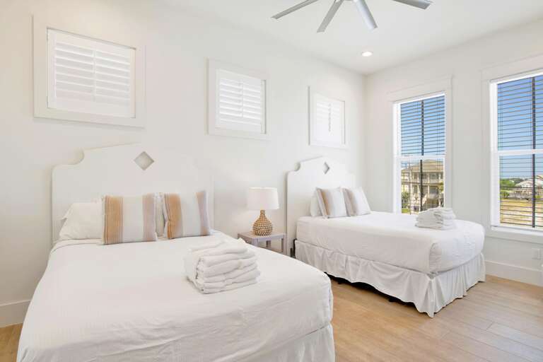 1 st floor bedroom with two sets of queens, sleeps 4.