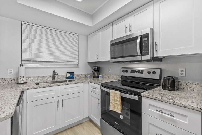 The kitchen offers a delightful view and includes everything you need to kickstart your vacation.