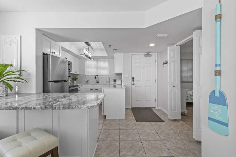 Polished Kitchen And Pristine, Sleek Space With Stainless Steel Appliances And Pale Palette