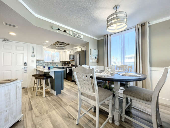 Our dining room kitchen combo combines modern elegance with panoramic pool and patio vistas.