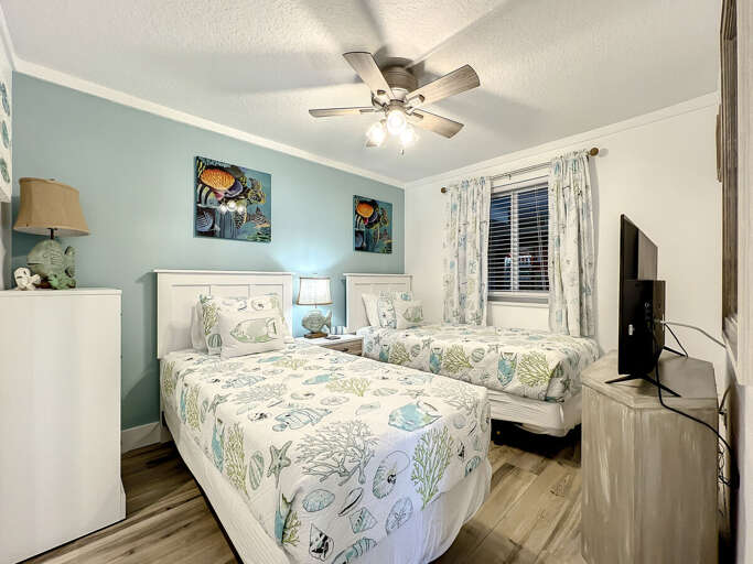 Our guest bedroom with twin beds offers cozy comfort and dreamy ocean breezes.