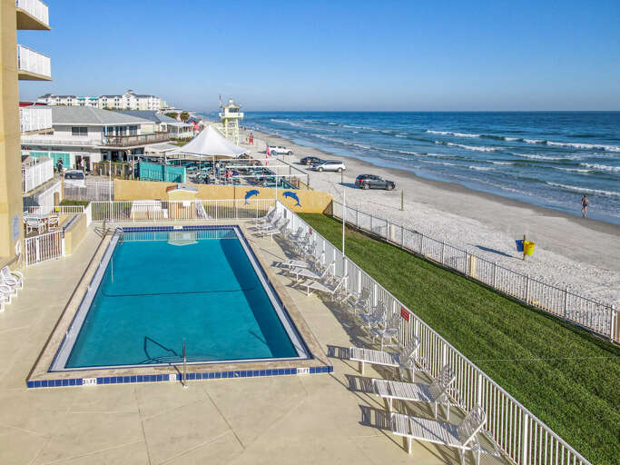 Lounge by the pool with beach views, where every moment is a tranquil escape.