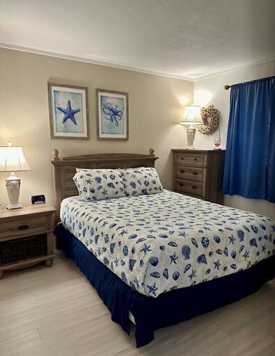 Drift off in this cozy coastal room, featuring shell-patterned bedding, nautical artwork, and warm, beach-cottage vibes throughout. Drift off in this cozy coastal room, featuring shell-patterned bedding, nautical artwork, and warm, beach-cottage vibes throughout.