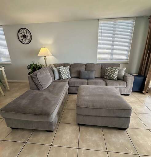 Sink into this plush sectional surrounded by soft lighting and sunny windows—ideal for relaxing after beachside adventures. Sink into this plush sectional surrounded by soft lighting and sunny windows—ideal for relaxing after beachside adventures.