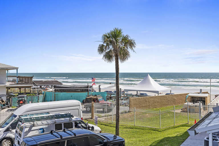 Take in the sights and sounds! The balcony with seating offers a side view of the ocean, where you can hear the waves