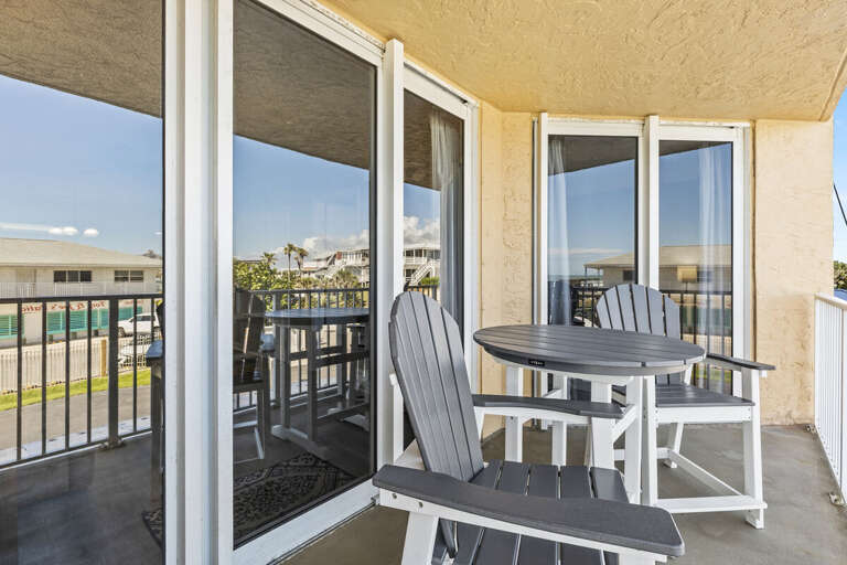 Take in the sights and sounds! The balcony with seating offers a side view of the ocean, where you can hear the waves